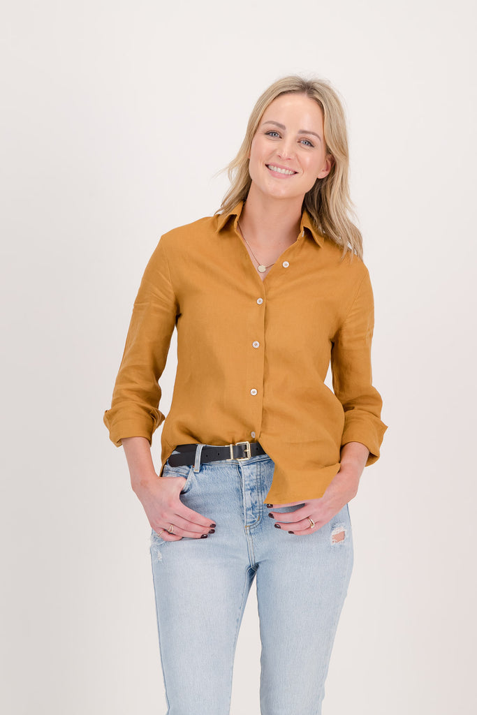 Woman with yellow shirt standing facing forwards