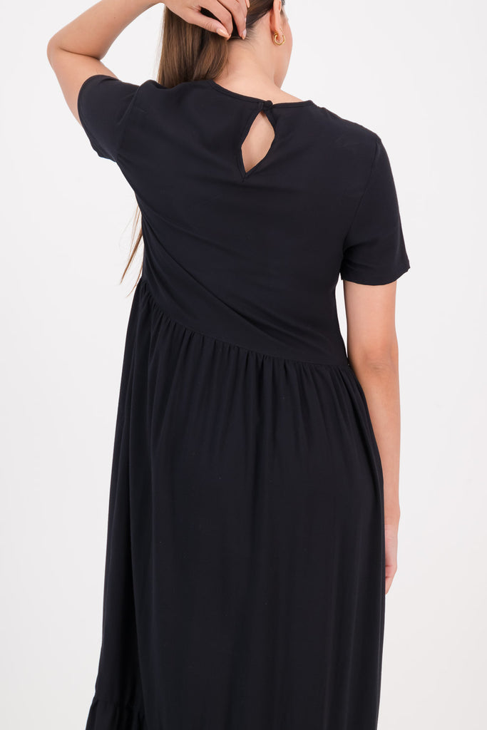 Woman wearing a black Zozi Dress facing backwards