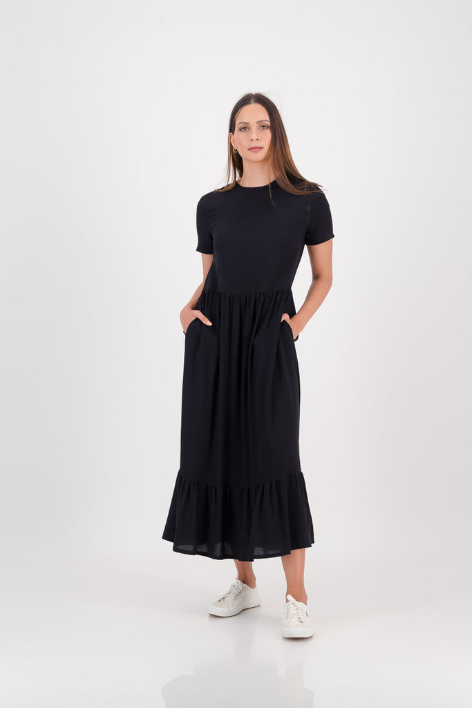 Woman wearing a black Zozi Dress facing forwards