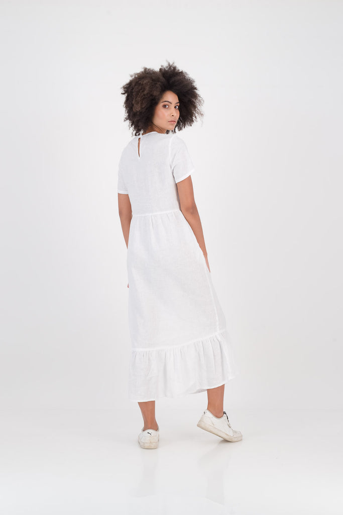 Woman wearing a white Zozi Dress facing backwards
