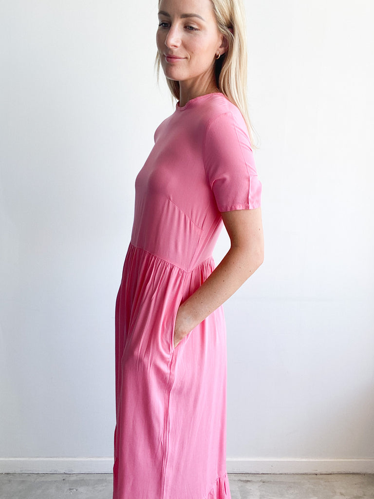 Woman wearing a barbie Zozi Dress facing sideways