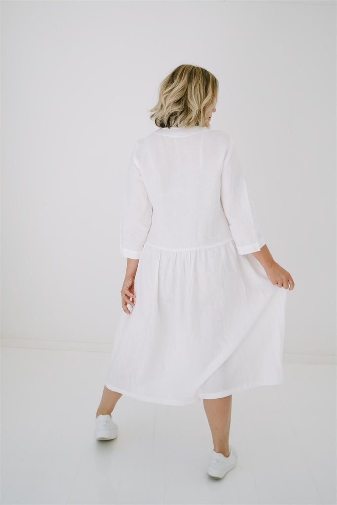 Woman wearing a white Petal Dress facing backwards